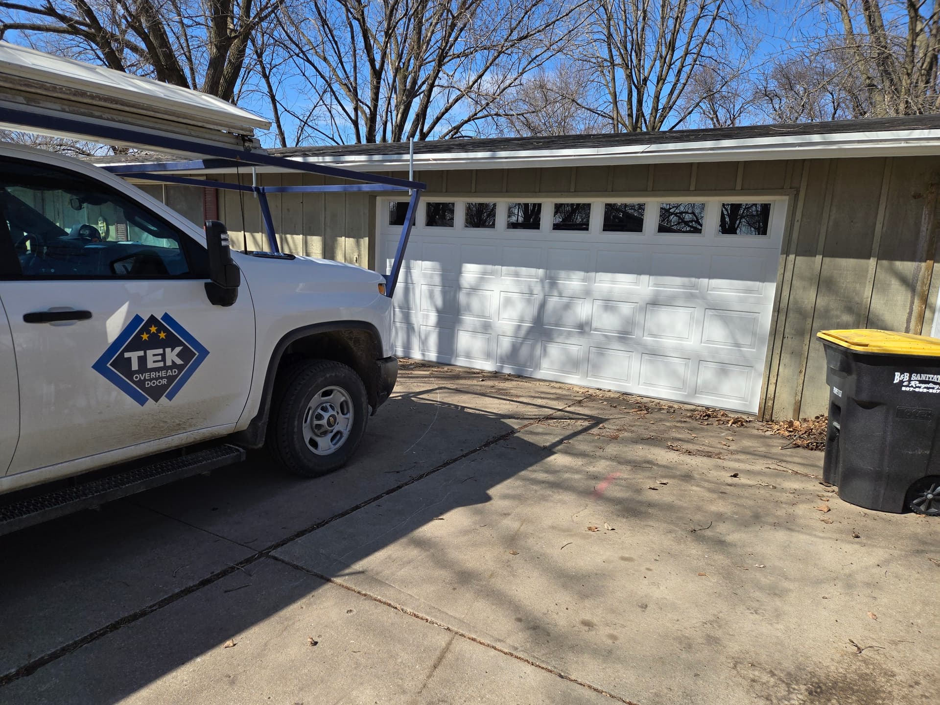 Garage Door Upgrade with a 16x7 White Colonial Door image