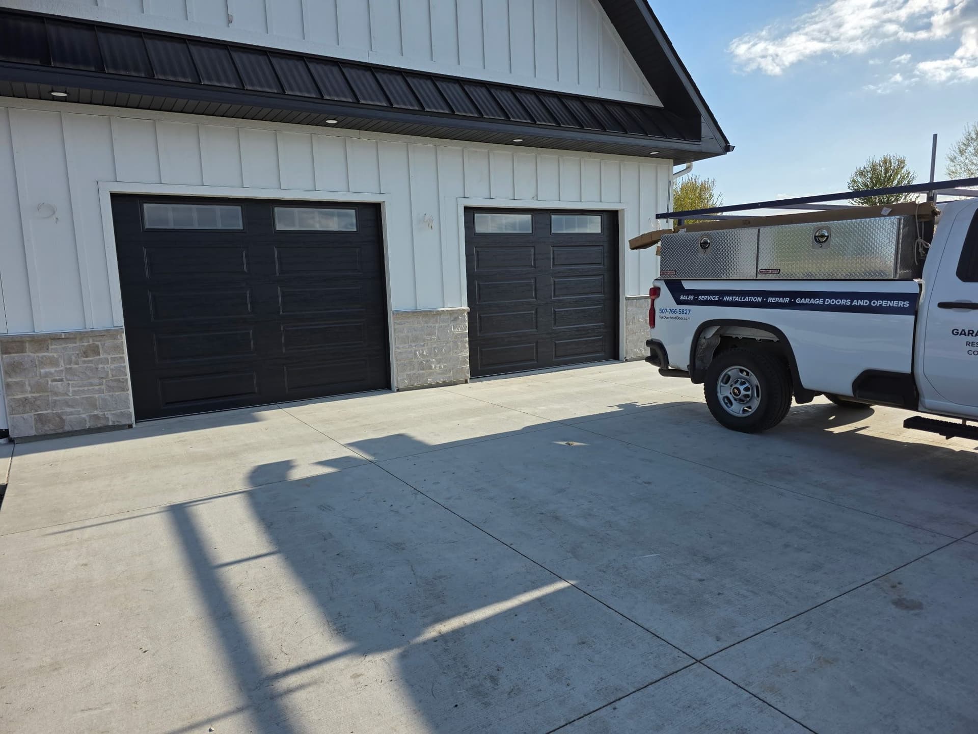 Two Modern Black Garage Doors Installed on a New Construction Home image