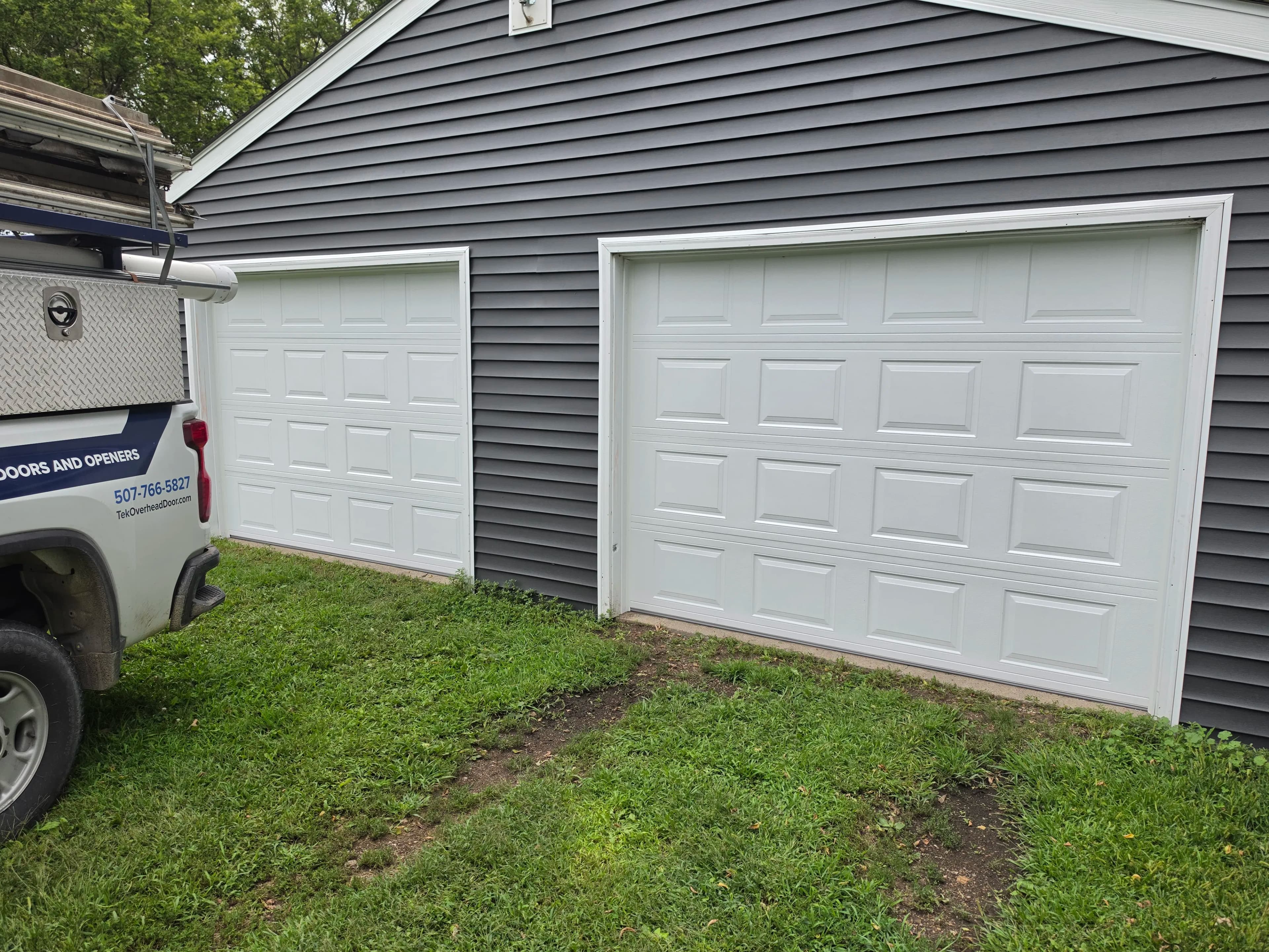 Project Two 9x7 White Raised-Panel Garage Doors Installed image